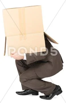 Businessman in suit wearing carton box on head Stock Photos