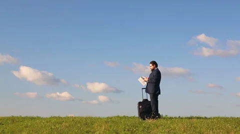 Businessman with suitcase and map Stock Footage 67696351