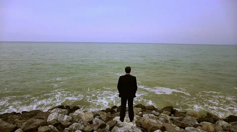 Businessman with suitcase on the beach Stock Footage 65001645