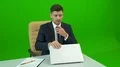 The businessman with a suitcase working at the desk on the green background 4k or 4k+ Resolution