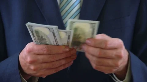 Businessman in Suits Counting Bunch of USD Dollar Money Video stock 76514904