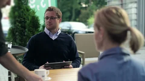 Businessman with tablet computer gets coffee in the cafe HD Video stock 11873891