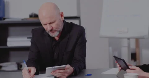 Businessman with tablet PC working in office Stock Footage 171580347