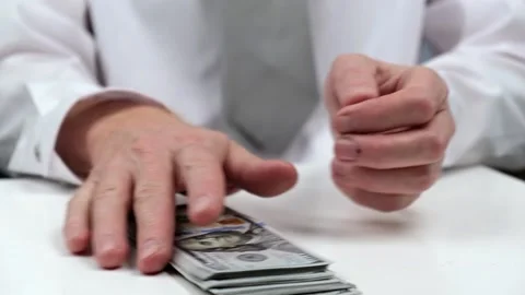A businessman takes a stack of hundred-dollar bills from the table. close-up. Stock Footage 176372920