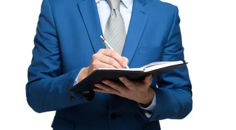 Businessman taking note using pen and notepad Stock-Fotos
