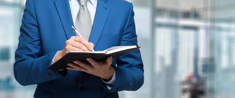 Businessman taking note using pen and notepad 写真素材