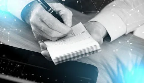 Businessman taking notes on notebook; light effect 스톡 사진