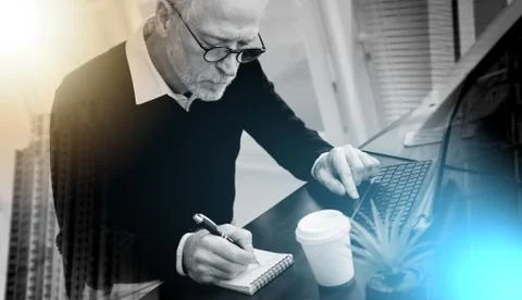 Businessman taking notes on notebook; multiple exposure Stock Photos