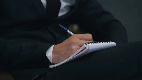 Businessman taking notes in notepad close up Stock Footage 150230011