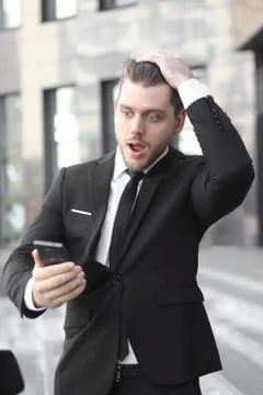 Businessman taking a selfie on the background of an office building Stock Photos