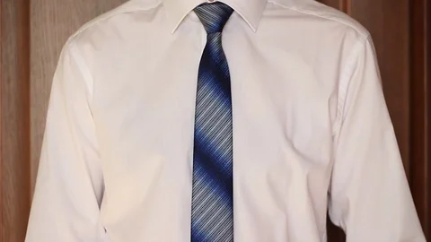 Businessman taking off a tie Stock Footage 70943216