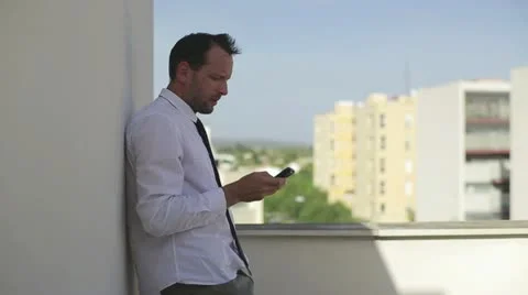 Businessman talking on cellphone, outdoor Stock Footage