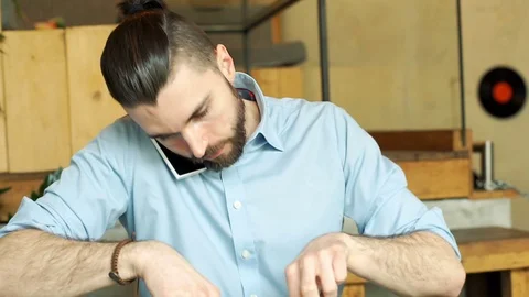 Businessman talking on cellphone while eating lunch in the cafe, steadycam shot Stock-Footage 73301345