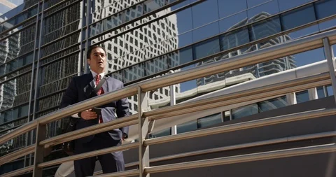 Businessman talking on an iPhone using AirPods Stock Footage 107636436