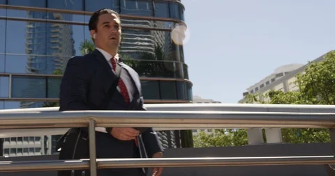 Businessman talking on an iPhone using AirPods Stock Footage 107636486