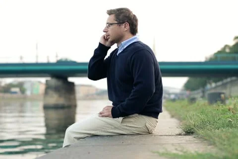 Businessman talking on mobile phone in the city, dolly shot NTSC Stock Footage