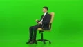 The businessman talking on the office chair on the green background 4k or 4k+ Resolution