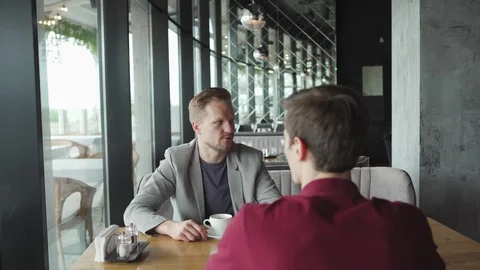 Businessman talking to partner in cafe Stock Footage 111755751