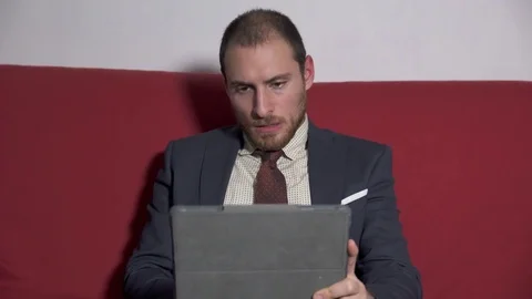 Businessman talking with a partner through the tablet Stock Footage 74693384