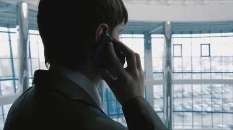 Businessman talking on the phone in the elevator going down Stock Footage 61539514