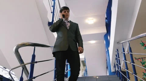 Businessman talking on the phone on the stairs Stock Footage 61541253