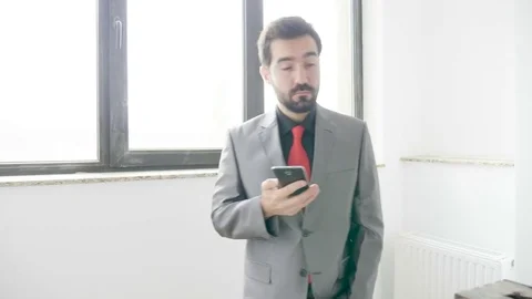 Businessman talking on the phone while climbing stairs in an office building Stock Footage 82748349