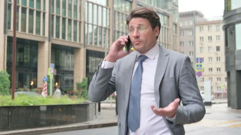 Businessman Talking on Phone while Walking on Street Video stock 158801901