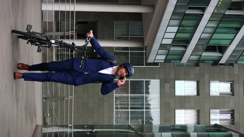 Businessman Talking on Phone while Walking with Electric Folding Bike in Ci.. Stock Footage 267449987