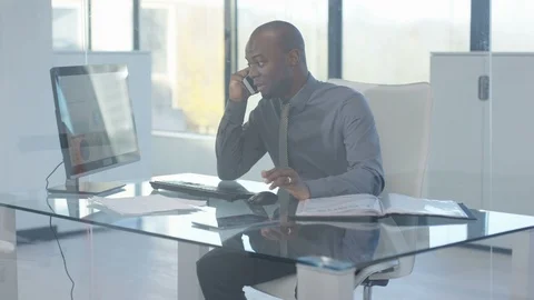 Businessman talking on phone while working on computer Stock Footage 107619391