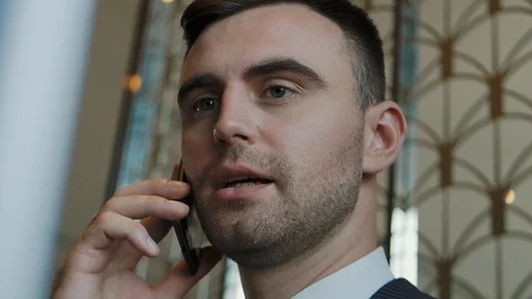 A businessman is talking on the phone working at a computer. Stock Footage 123874440