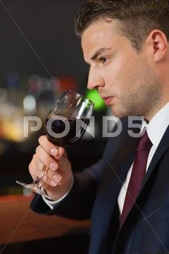 Businessman tasting red wine Stock Photos
