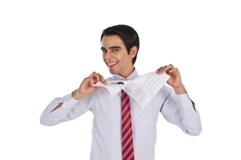 Businessman tearing a paper and smiling Stock Photos