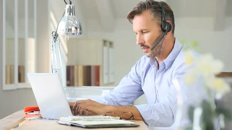 Businessman teleworking, headset on Stock Footage 56057679