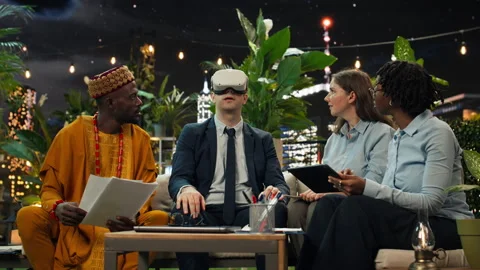 Businessman testing VR headset at rooftop team demonstration Stock Footage 347815943