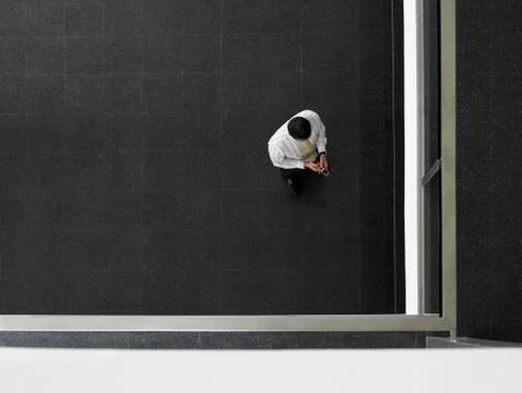 Businessman Text Messaging In Corner Stock Photos