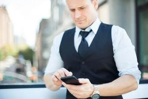 Businessman text messaging with smartphone Stock Photos