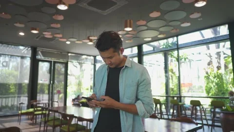 Businessman texting on smart phone while sitting in Cafe. Stock-Footage 234975397