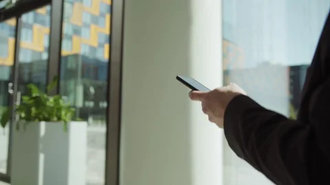 Businessman texting on smartphone while walking in hall Stock Footage 108679504