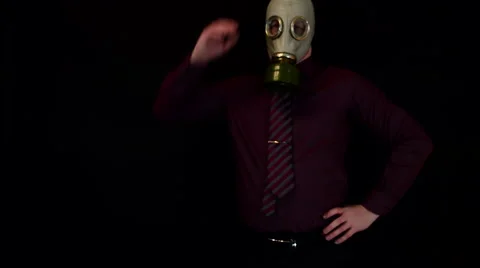 Businessman thinking and scratching her head in a gas mask on a black Stock Footage 60186497
