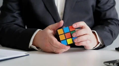 Businessman Thinking of Bussiness Problem and Playing with Rubik's cube Stock Footage 87994235