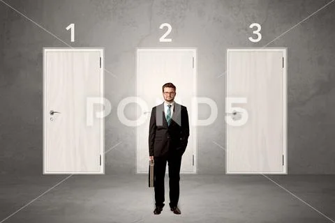 Businessman thinking in front of three doors Stock Photos
