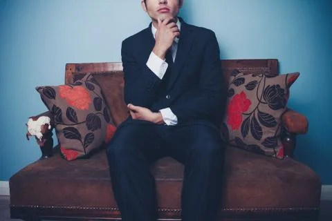 Businessman thinking on sofa Stock Photos
