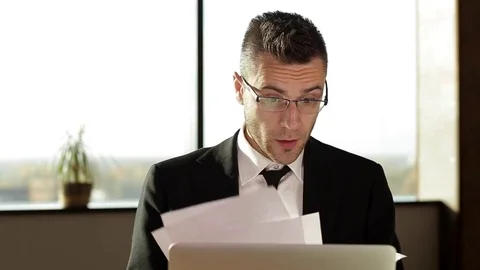 Businessman throwing document while sitting at your desk in the office 動画素材 70838946