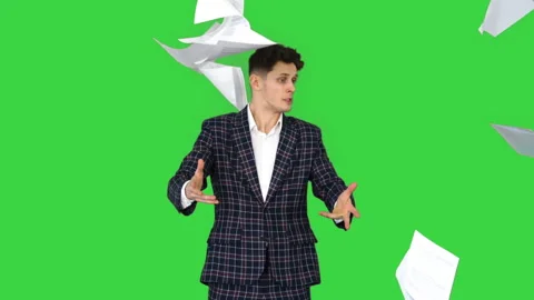 Businessman throws up documents and dances happy on a Green Screen, Chroma Key. Stock Footage 140534255