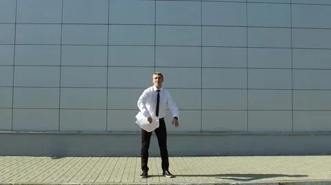 Businessman throws up the paper and do back flip. Slow motion Stock Footage 67343807