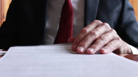 Businessman thumbing through documents Stock Footage 62019796