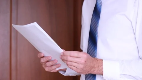Businessman thumbing through documents Stock Footage 90834005