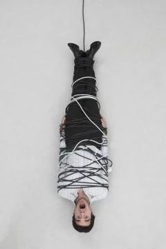 Businessman tied up with computer cable, elevated view Stock Photos