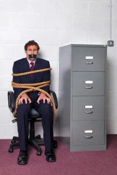 Businessman tied up in the office Stock Photos