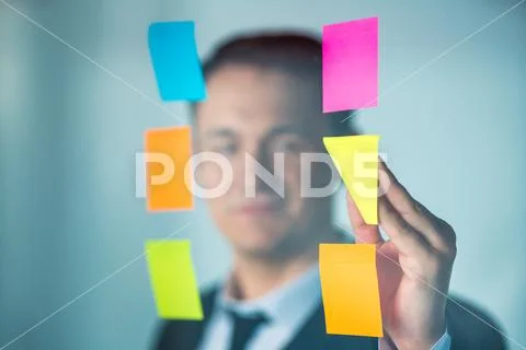 The businessman touch the sticker on the window Stock Photos